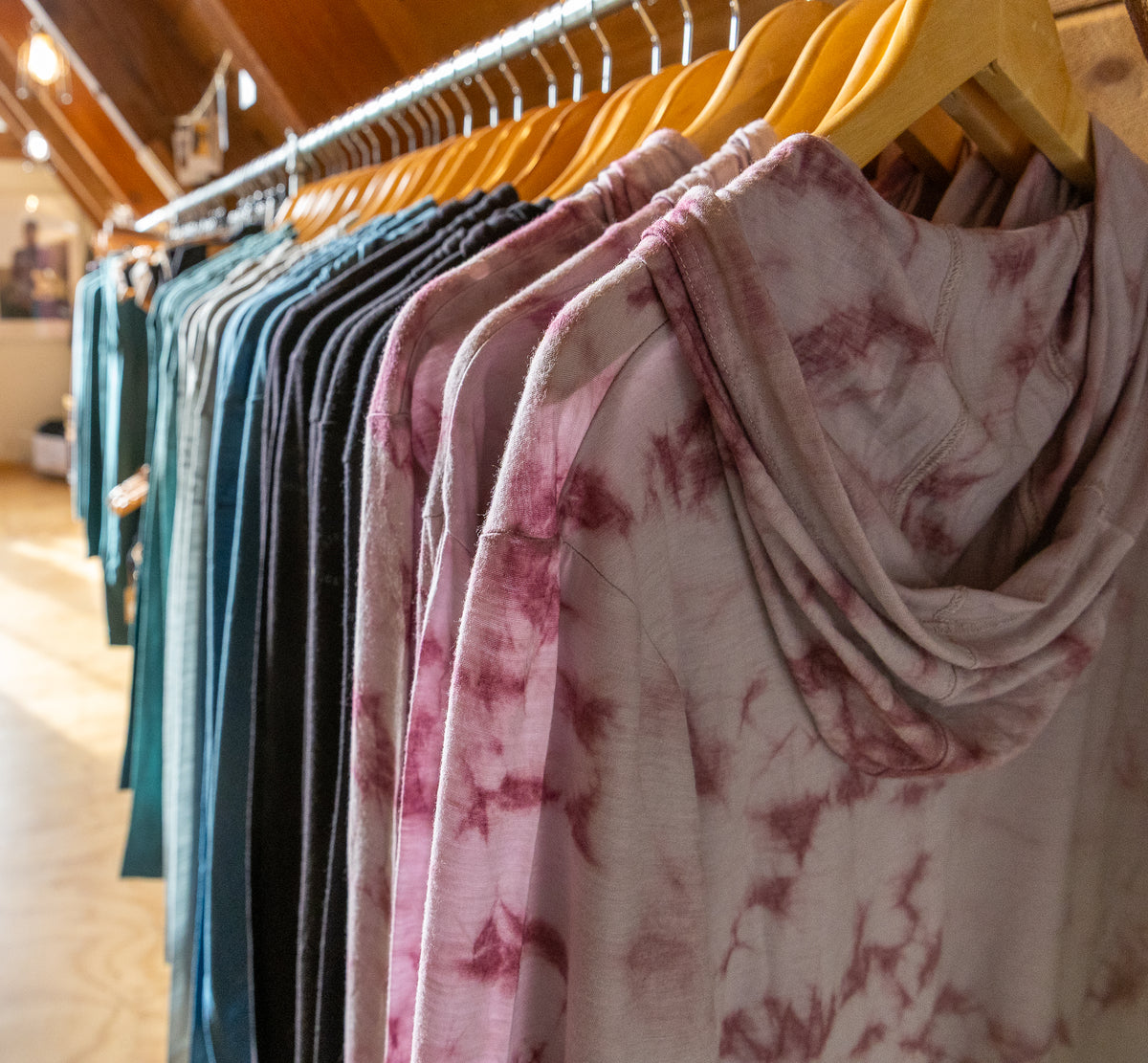 Row of colorful scarves on a rack in a store setting